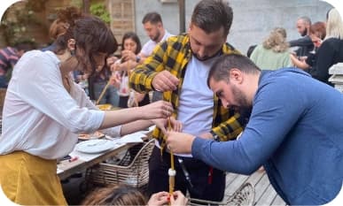 3 people playing the marshmallow challenge