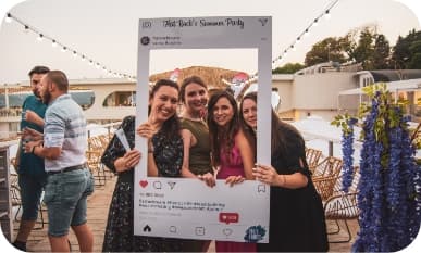 3 ladies posing with party frame on a summer party