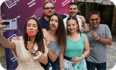 6 people posing for a selfie with party decoration